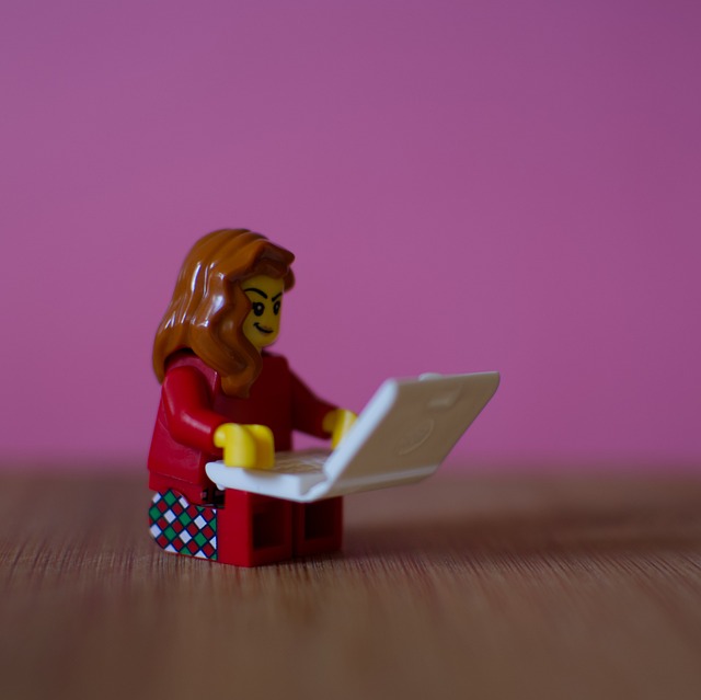 Lego girl using laptop computer perhaps to welcome visitors to her blog.