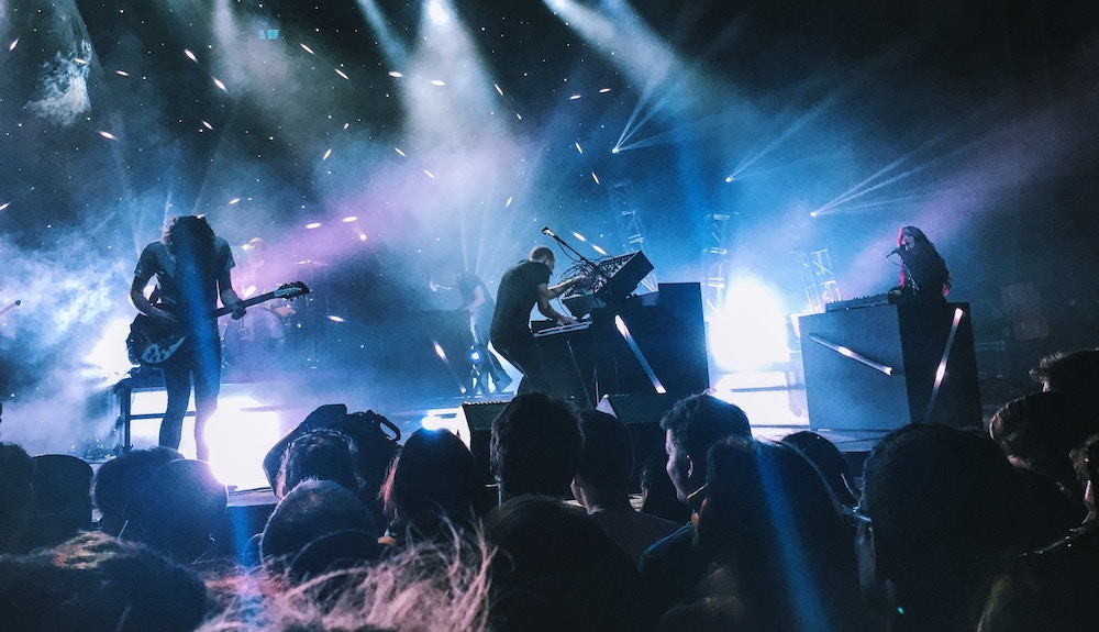 stock photo of a rock band on stage to depict a fantasy rock band example of symbolic convergence theory.