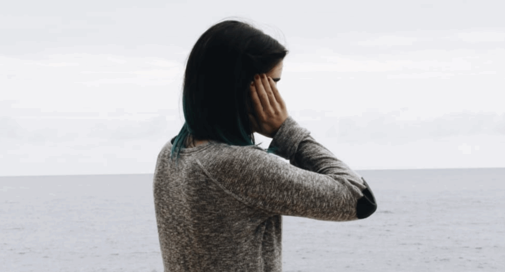 woman covering ears with her hands