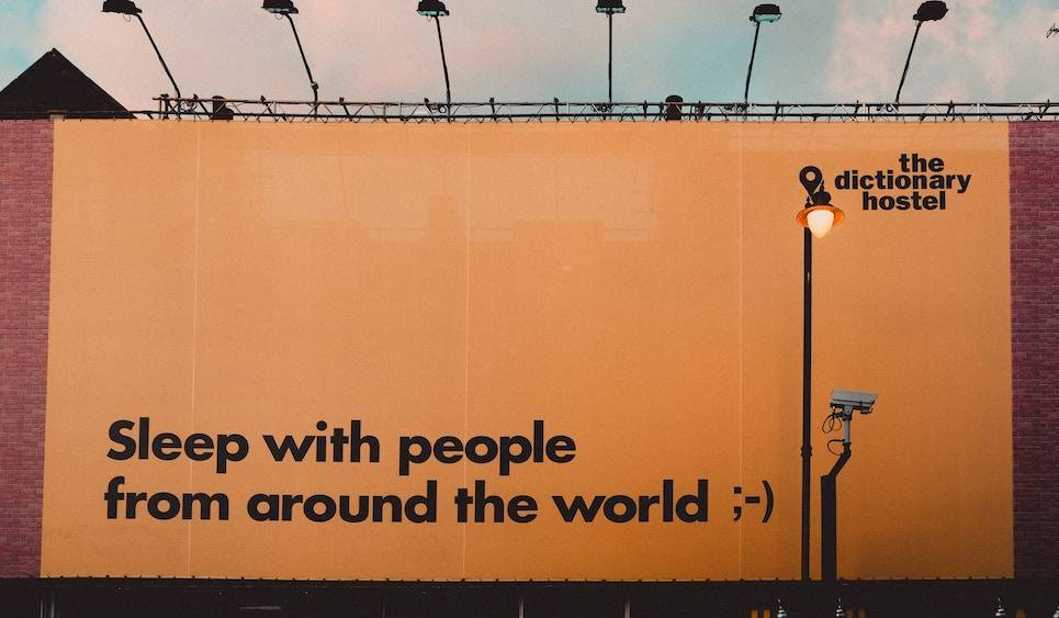 Sleep with people from around the world billboard advertisement